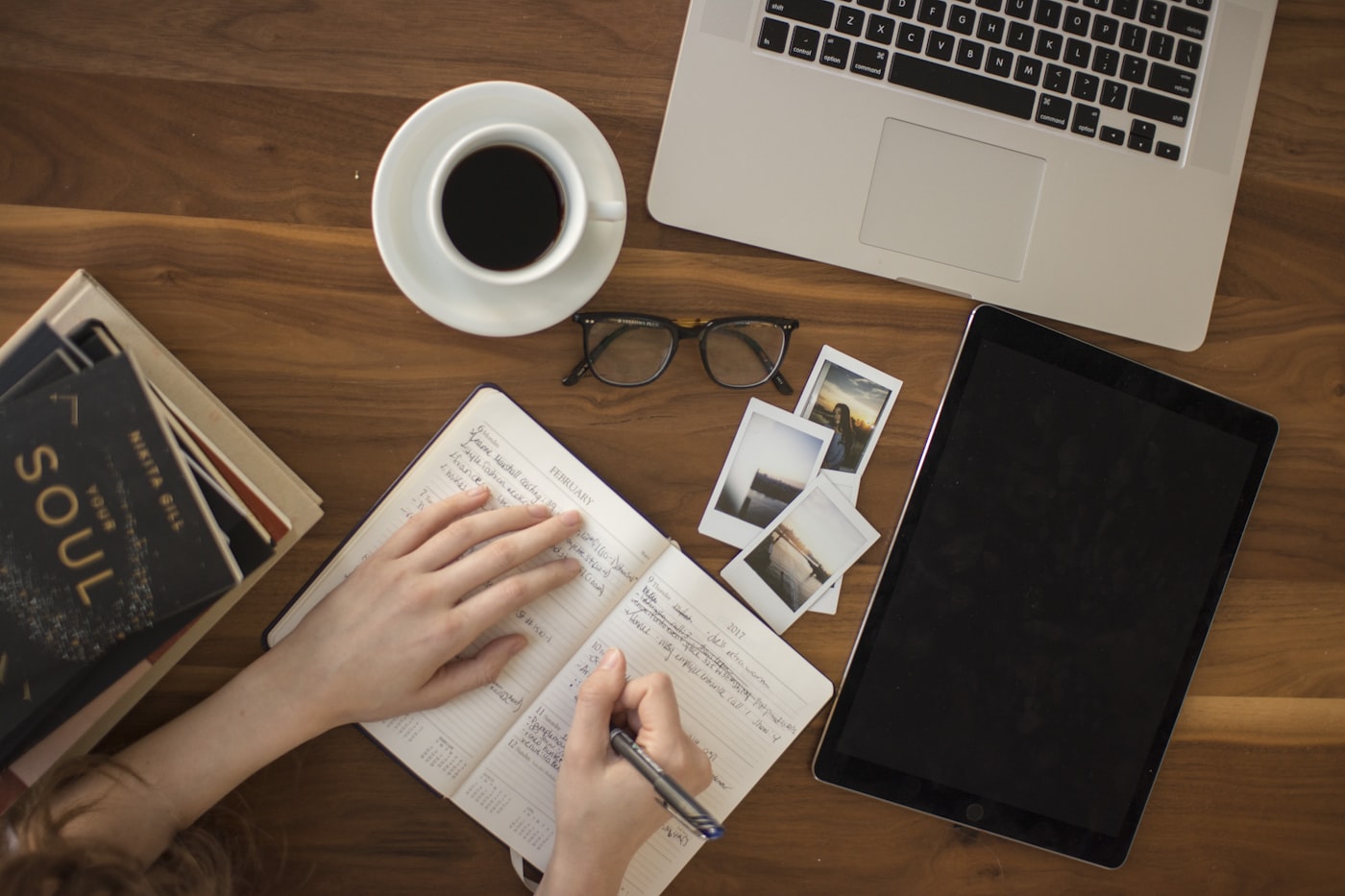 Journaling and planning how to choose a blog niche, notebook and laptop with coffee on a desk