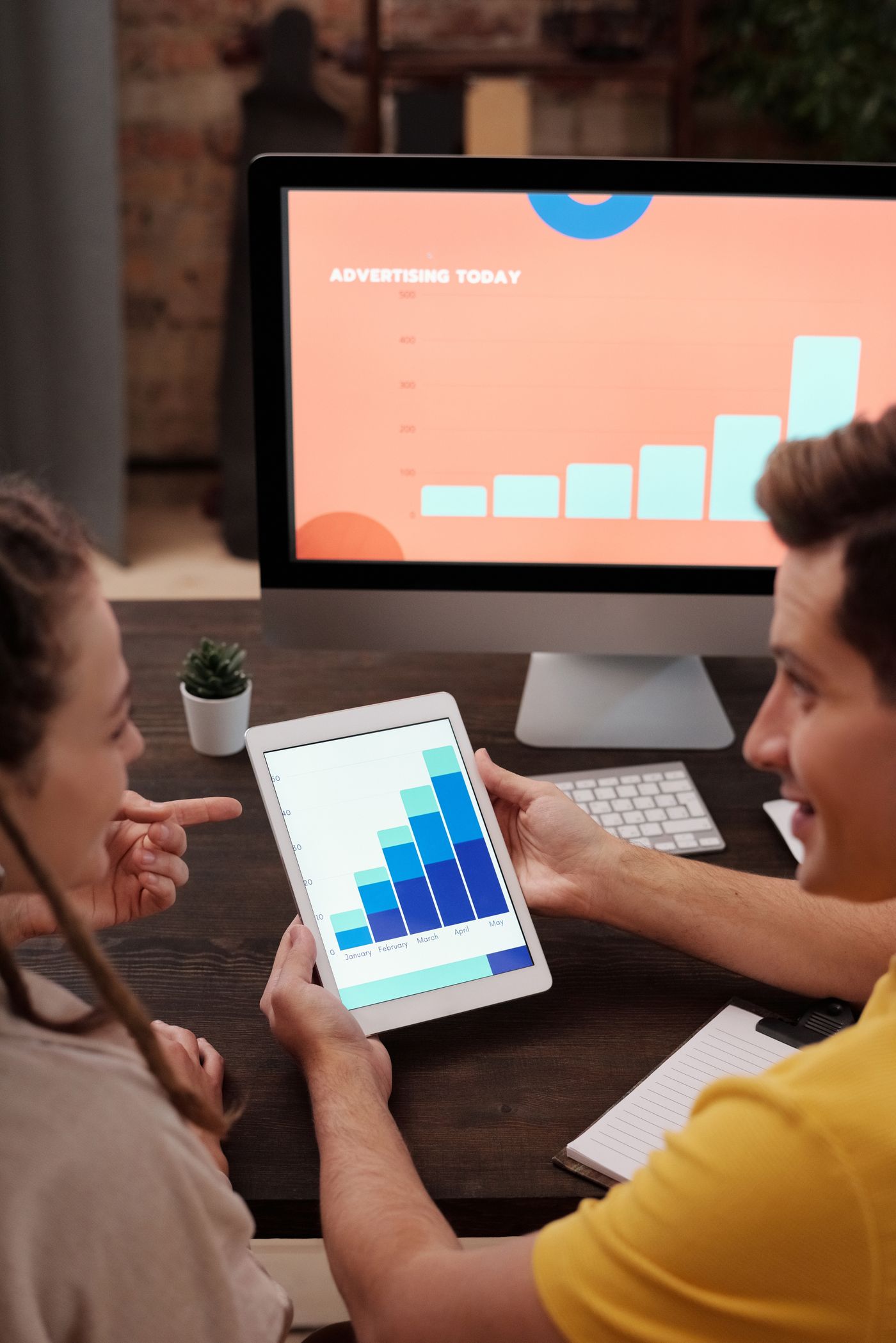 Marketing team reviewing a Google Ads campaign dashboard together on a laptop
