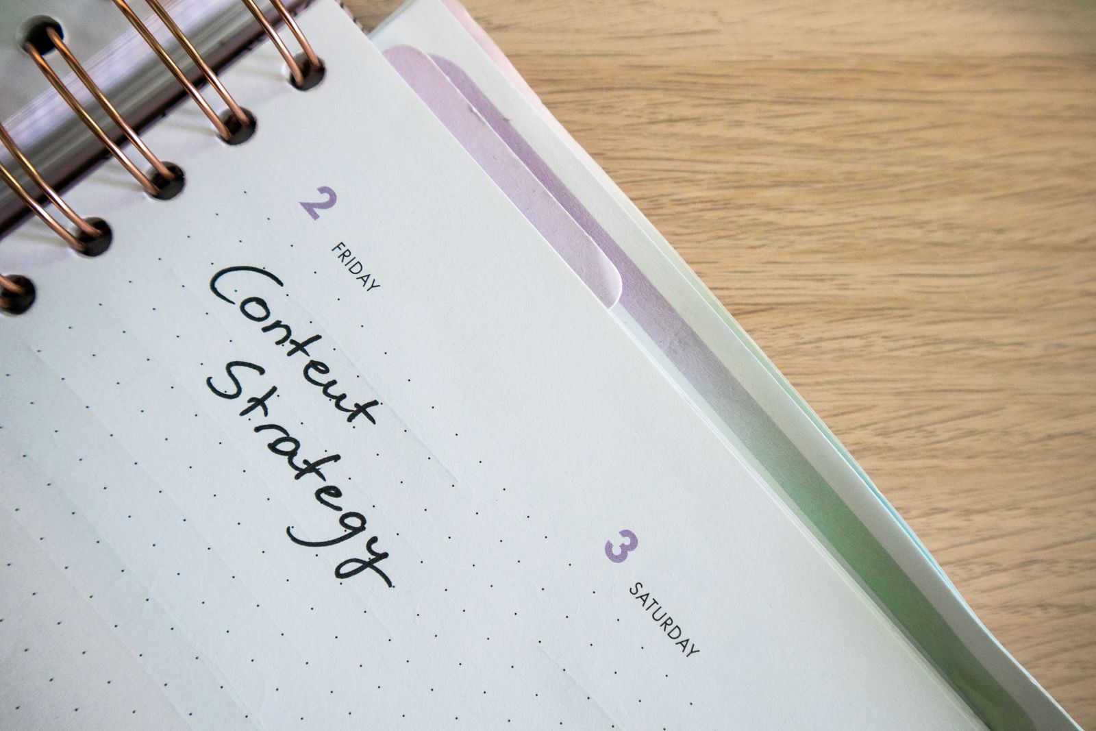 Weekly planner open to a dotted-grid page with "Content Strategy" handwritten for Friday